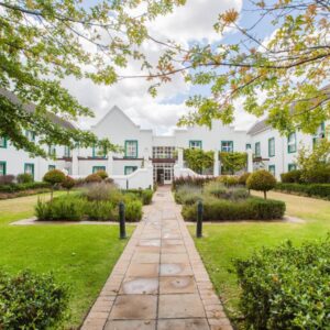 City Lodge Hotel GrandWest: an exterior view of a white building with a garden