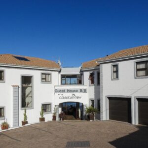 Classical View Guesthouse: a large white building with a first house bc dispensary