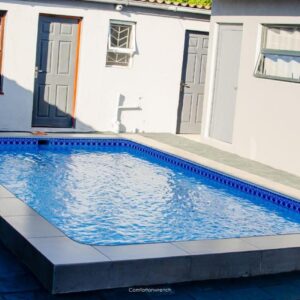 Comfort on Wrench: a swimming pool in front of a house
