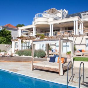 Compass House Boutique Hotel - Adults Only: a large white house with a swimming pool