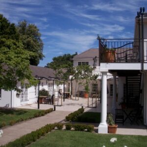 Constantia White Lodge Guest House: a white house with a balcony and a courtyard