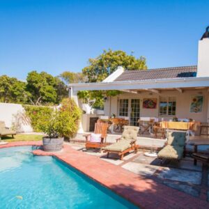 Cornerway House: a backyard with a swimming pool and a house
