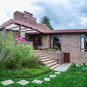 Cosy-Corner Guest House, George: a brick house with a garden in front of it