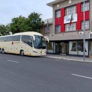 Cumberland Hotel & Conference Centre Worcester: a white bus parked in front of a building