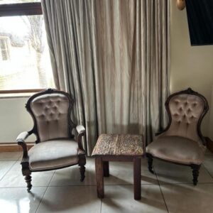 Daisy Accommodation & Spa: two chairs and a table in front of a window