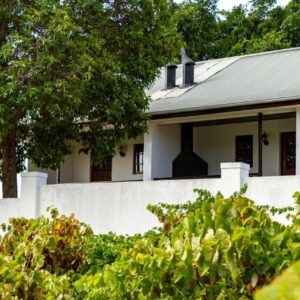 D'Aria Guest Cottages: a white house with a fence and trees