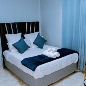 DC Guest House: a blue bedroom with a bed with a teddy bear on it