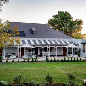 De Denne Country Guest House: a white house with a large yard