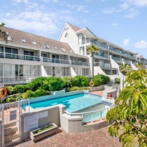 Dolphin Beach Hotel by Singer Group: an exterior view of a building with a swimming pool