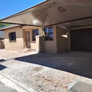 Duminy Guest Lodge: a garage with awning over a house