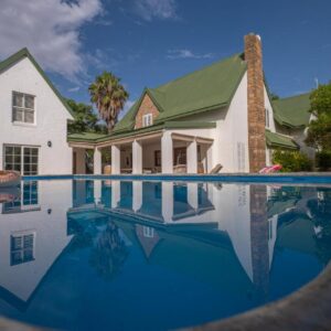 Eden Studios: a house with a swimming pool in front of a house