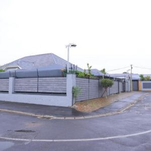 Eternal Guest House: a white fence in front of a parking lot