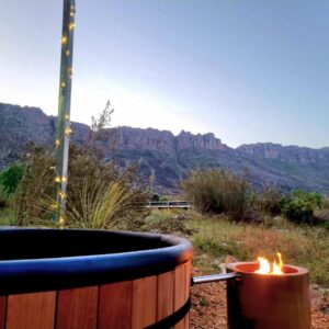 Fairfield Cottages: a hot tub with a candle in front of a mountain