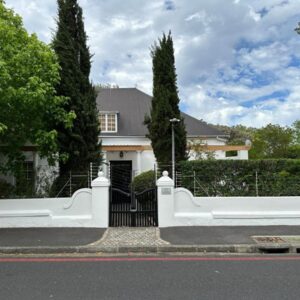 Falcon House Luxury Apartments: a white fence in front of a house