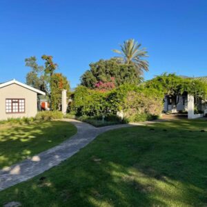 Farmlands Guesthouse: a driveway leading into a yard with a house