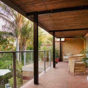 Feather Nest Guest House: an outdoor patio with an umbrella and a table and chairs