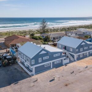 Fork West Holiday Apartments: an aerial view of a house and the beach