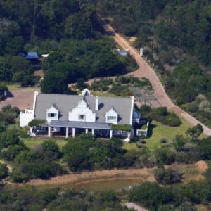 Fynbos Ridge Country House & Cottages: an aerial view of a large white house on a hill