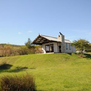 Galileo Farm: a small house on top of a grassy hill