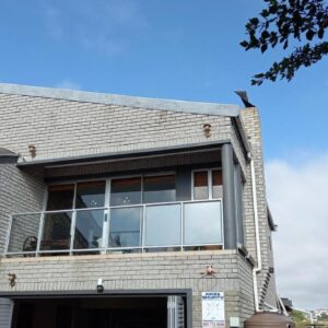 Geluksfontein apartments: a house with a large window on the front of it