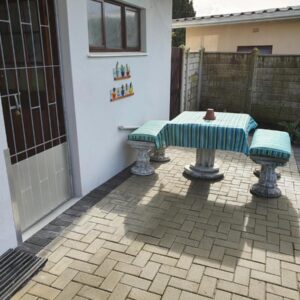GlassTree B&B: a table and two benches on a patio