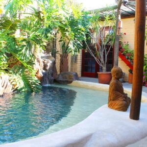 Goblin's Mead: a statue sitting next to a pool in a resort