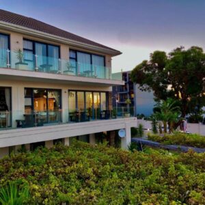 Grande Hotel: a building with balconies and tables and a tree