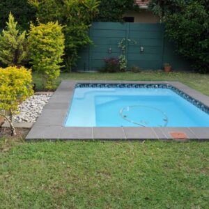 Greenlawns B&B: a swimming pool in a yard with a grassy yard