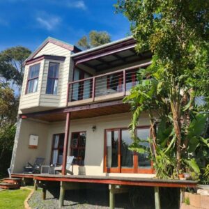 Happy Homes - Imhoffs Gift: a house with a balcony and a tree