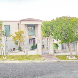 Harbour Pearl Guest House: a white house with a fence and trees