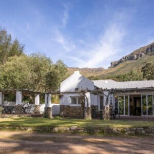 HEIDI'S ALM Retreat and Cottage: an exterior view of a house with mountains in the background
