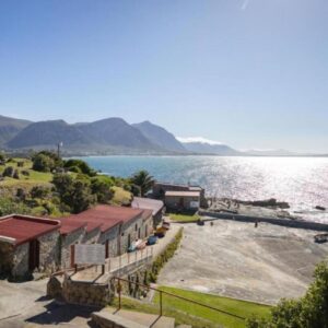 Hermanus Waterfront Apartments: a building next to a body of water