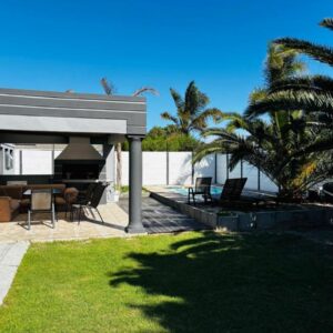 HideAway Haven: a house with a patio with a table and chairs