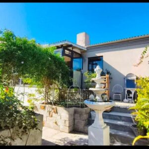 House of Serendipity: a house with a fountain in the front yard
