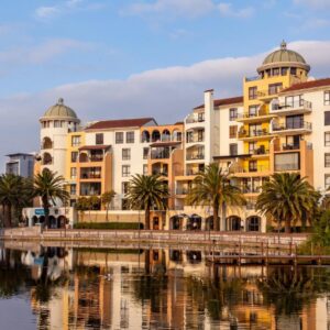 Island Club Hotel & Apartments: a group of buildings next to a body of water