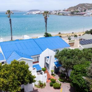Jane's Guesthouse: an aerial view of a house with solar panels on the beach