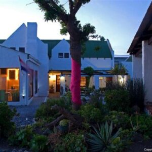 Kaijaiki Country Inn and Restaurant: a house with a pink scarf wrapped around a tree