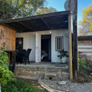 Karoo Soul: a small white house with a porch with a table