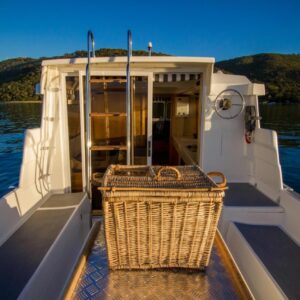 Knysna Houseboats: a basket on the front of a boat on the water