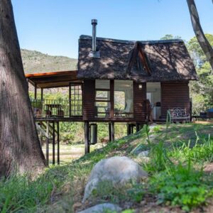 La Ferme Guest Farm - Hot Tubs - Fishing: a small wooden house with a tree