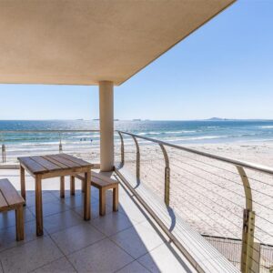 Lagoon Beach Hotel & Spa: a balcony with a table and benches on the beach