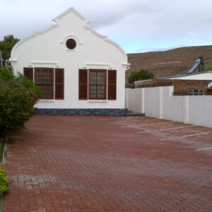 Laings Lodge: a white house with a brick driveway