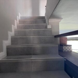Lakeview lodge: a stairway in a house with a concrete staircase
