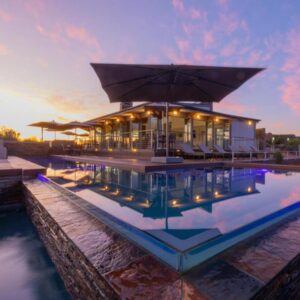 Landrani Luxury Lodge: a house with a pool in front of a building