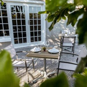 Le Petit Chateau Guest House: a table and chairs in front of a door