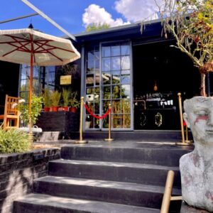 Le Rêve Boutique Hôtel: a statue in front of a building with an umbrella