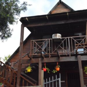 Lolita's: a house with a porch and a balcony