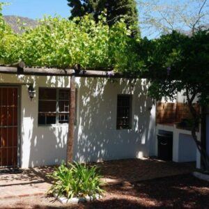 Long Acres Cottages: a white house with a tree in front of it