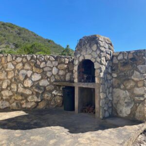 Long Thin Farm - Stilbaai Self-Catering Accommodation: a stone wall with a small oven in front of it