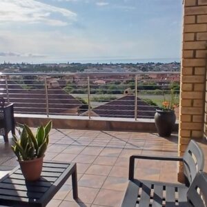 Lunava Retreat Luxury Holiday Accommodation: a balcony with a table and chairs and a view
